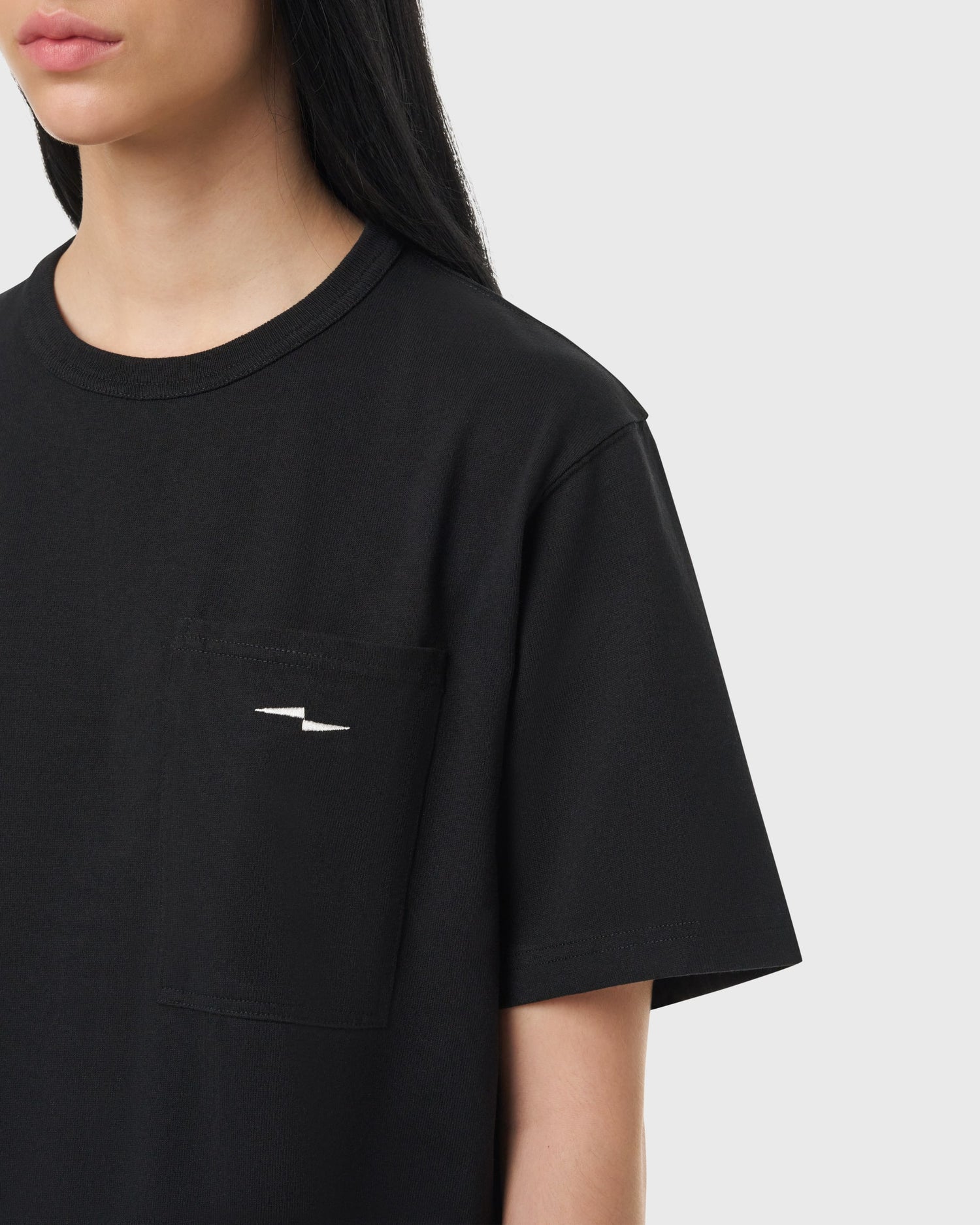 Détail du logo Avnier sur le T-shirt noir Prelude, tissu épais et résistant.