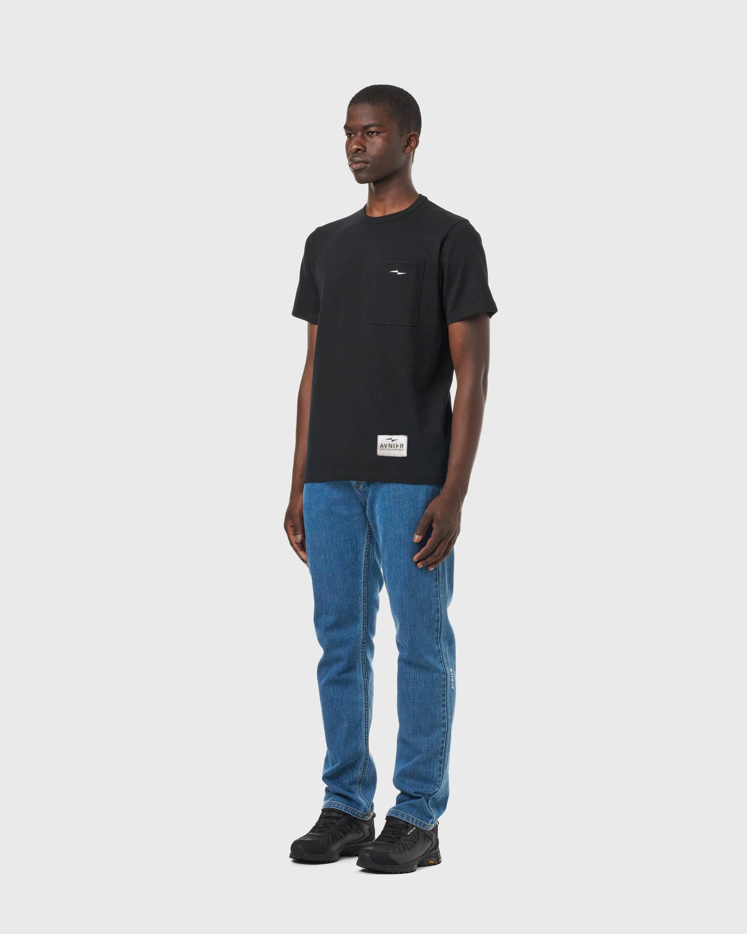 T-shirt noir Avnier Prelude porté, vue de profil — look inspiré du cinéma et du travail technique.